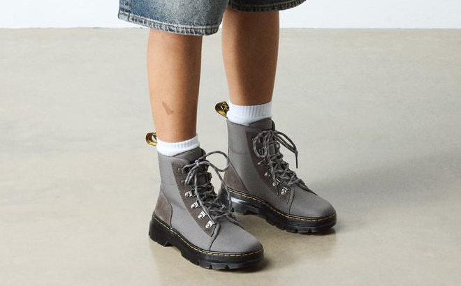 A Person wearing Dr Martens Womens Suede Utility Boots