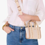 A Person wearing a Kate Spade Outlet Kip Canvas Mini Tote Bag