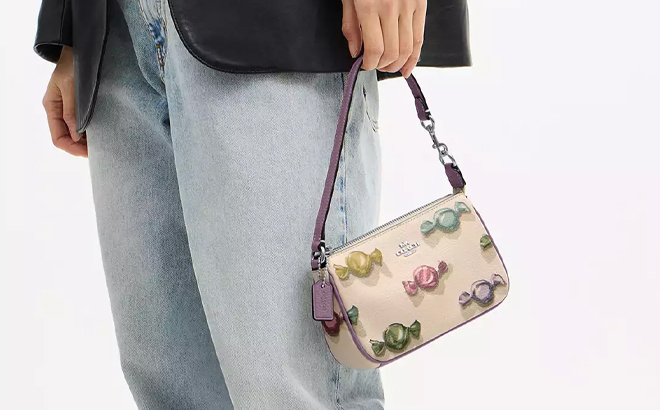 A Woman Holding Coach Outlet Nolita 19 With Candy Print