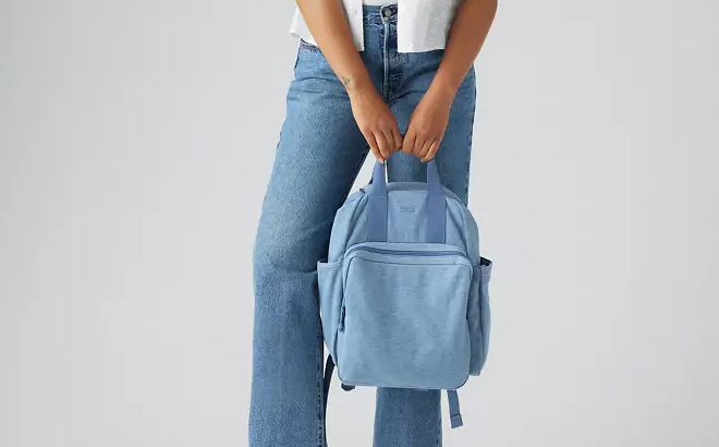 A Woman Holding Levis L Pack Round Backpack A Woman Holding Levis L Pack Round Backpack