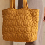 A Woman Holding Vera Bradley Disney Vera Tote Bag