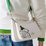 A Woman Wearing Kate Spade x Peanuts Snoopy Small Crossbody