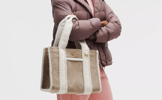 A Woman Wearing Lululemon Faux Shearling Trims Boxy Tote Bag