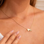 A Woman Wearing Turandos Heart Initial Necklace