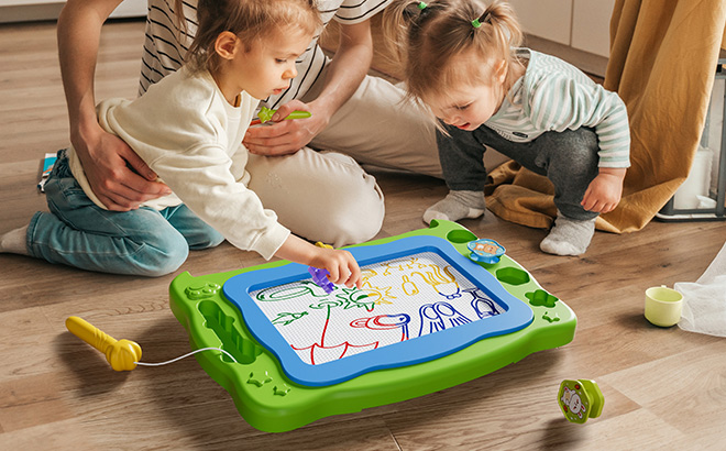 Children Playing with a Magnetic Drawing Board