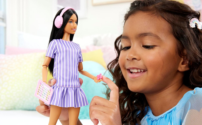 Kid Playing with Barbie Autistic doll Kid Playing with Barbie Autistic doll