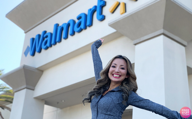 A Smiling Woman Jumping in Front of a Walmart Store with the Store Sign Behind Her