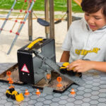 A Boy Playing with the CAT Construction Toys Playset