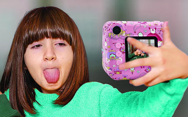 A Child Using an All Over Printed Instaprint Camera