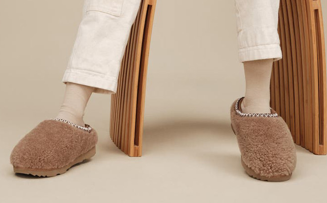 A Child Wearing UGG Kids Tasman Maxi Curly Slippers A Child Wearing UGG Kids Tasman Maxi Curly Slippers