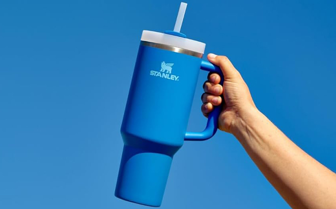 A Hand holding Stanley 40 Ounce Quencher H2 0 Tumbler in Azure Color