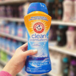 A Person Holding Arm Hammer Clean Scentsations In Wash Scent Boosters