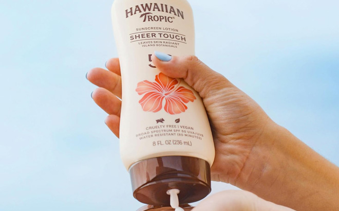 A Person Holding Hawaiian Tropic Sheer Touch Lotion Sunscreen A Person Holding Hawaiian Tropic Sheer Touch Lotion Sunscreen