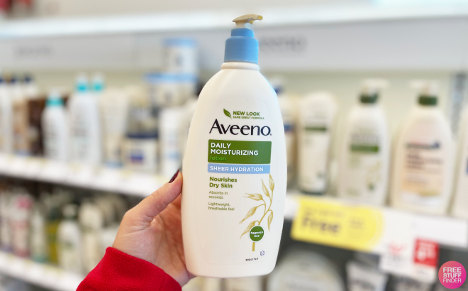 A Person Holding a Bottle of Aveeno Sheer Hydration Lotion A Person Holding a Bottle of Aveeno Sheer Hydration Lotion