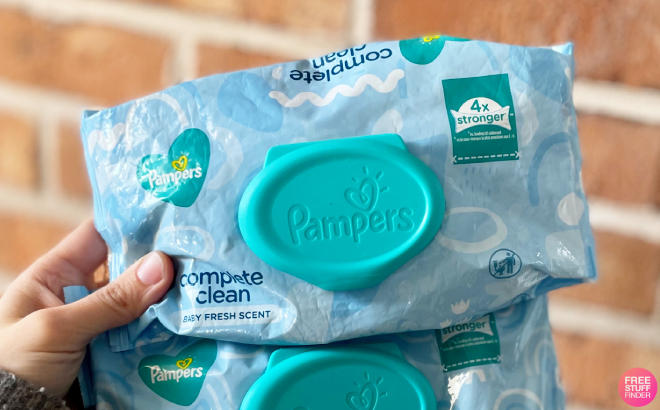 A Person Holding a Pack of Pampers Complete Clean Baby Wipes
