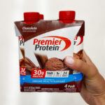 A Person Holding a Pack of Premier Protein Shake in Chocolate Flavor