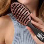 A Person Holding a Wet Brush Ceramic Speed Dry Hair Brush