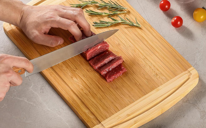 A Person Using Hiware Large Wooden Cutting Board
