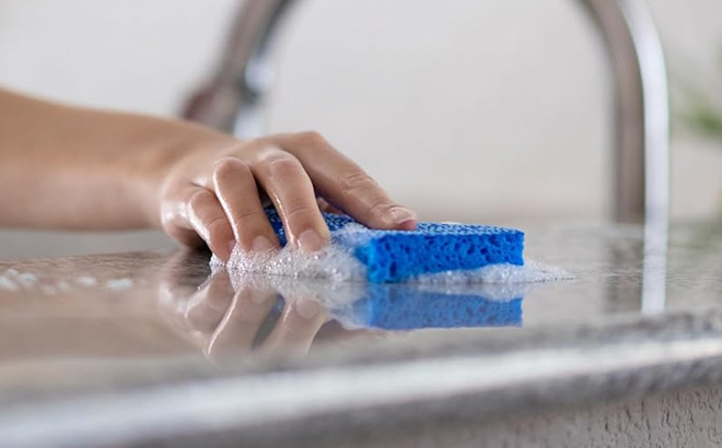 A Person Using the Scotch Brite Zero Scratch Scrub Sponge