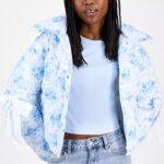 A Person Wearing Madden Girl Juniors Printed Bow Trim Puffer Jacket in Bright White and Blue