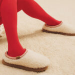 A Person Wearing a Pair of UGG Tasman Maxi Curly Genuine Shearling Slipper