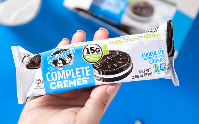 A Person holding a Lenny Larrys The Complete Cremes Sandwich Cookie
