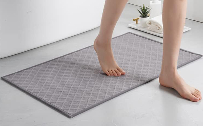 A Person stepping on a Amoami Ultra Thin Bath Mat