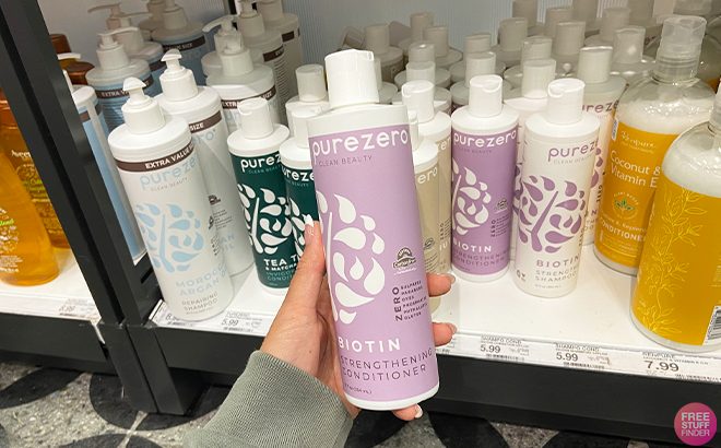 A Woman Holding Purezero Biotin Conditioner