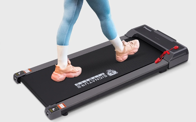 A Woman Using the BalanceFrom SlimFold Dual Mode Walking Pad A Woman Using the BalanceFrom SlimFold Dual Mode Walking Pad