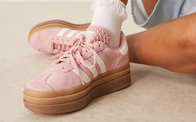 A Woman Wearing Adidas Originals Gazelle Bold Sneakers in Light Pink