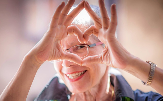 Older Woman Making Heart Symbol Shape with Hands