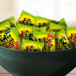 A Bowl with Sour Patch Kids Candy Snack Packs on a Table