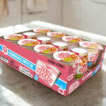 A Box of Nissin Cup Noodles Soup on a Table