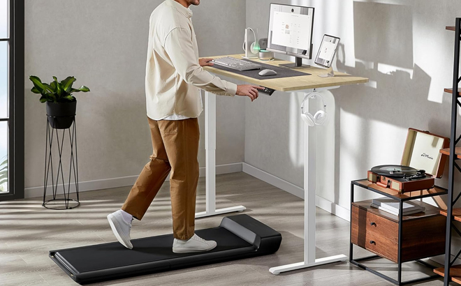 A Man Using WALKINGDESK 48x24 Inches Height Adjustable Electric Standing Desk