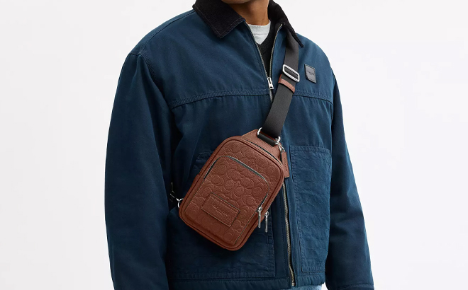 A Man Wearing Coach Outlet Racer Sling Pack In Signature Leather A Man Wearing Coach Outlet Racer Sling Pack In Signature Leather