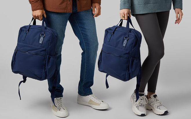 A Man and Woman Holding 32 Degrees Outdoor Backpacks