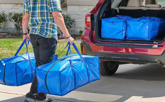 A Person Carrying Extra Large Moving Bags