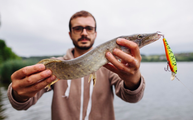 A Person Showing His Freshly Caught Fish