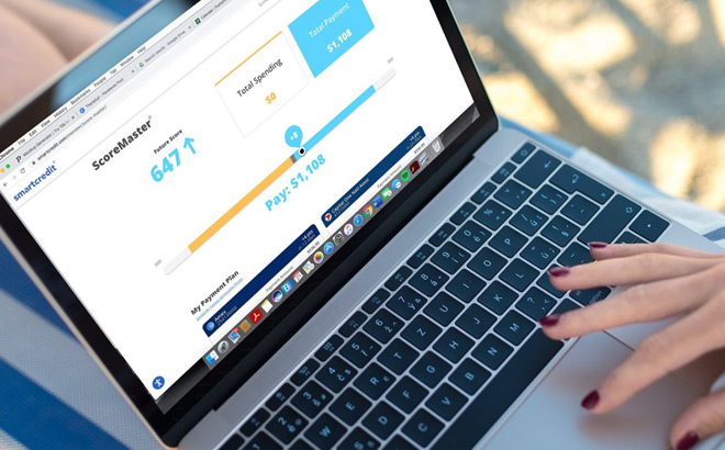 A Person Using SmartCredit ScoreMaster Tool on Laptop A Person Using SmartCredit ScoreMaster Tool on Laptop