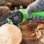 A Person Using a Tietoc 6 Inch Mini Electric Chainsaw