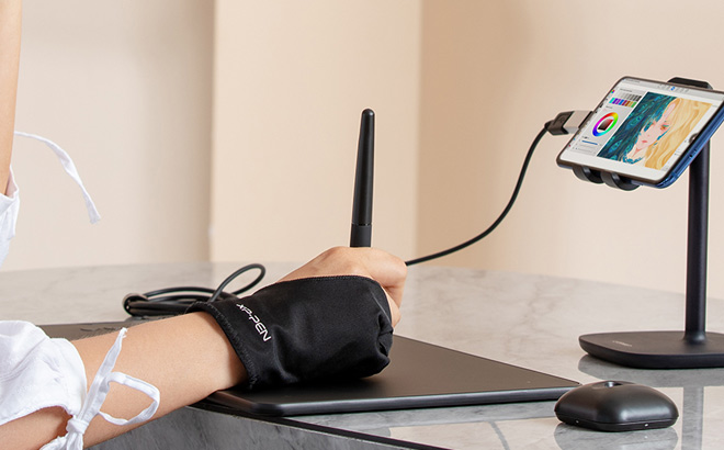 A Person Using an XP Pen Deco 01 V3 10 Inch Drawing Tablet