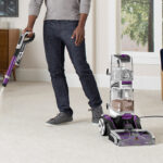 A Person Using the Hoover SmartWash Pet Automatic Carpet Cleaner