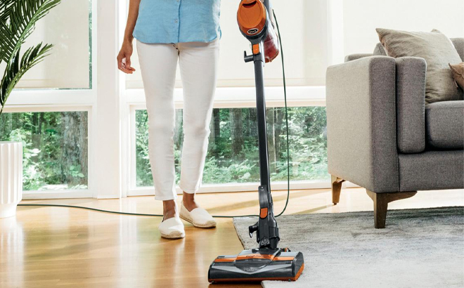 A Person Using the Shark Rocket Pet Corded Stick Vacuum