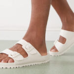 A Person Wearing Birkenstock Arizona EVA Slide Sandals in Eggshell Color