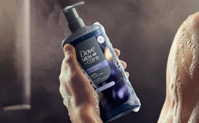 A Person holding a bottle of Dove Men Care Body Wash