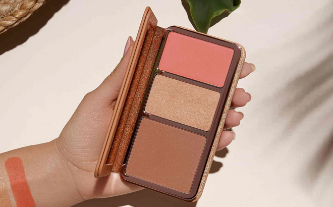 A Woman Holding Anastasia Beverly Hills Face Palette in Off to Costa Rica