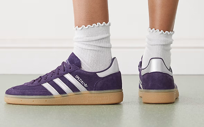 A Woman Wearing Adidas Originals Handball Spezial Sneakers in Dark Purple A Woman Wearing Adidas Originals Handball Spezial Sneakers in Dark Purple