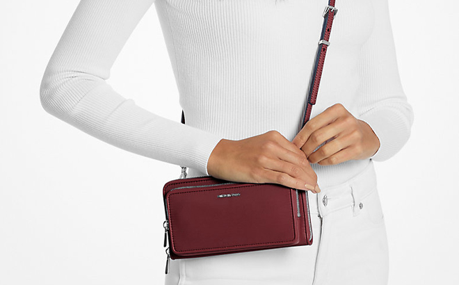 A Woman Wearing Michael Kors Jet Set Large Nylon Crossbody Bag in Oxblood A Woman Wearing Michael Kors Jet Set Large Nylon Crossbody Bag in Oxblood