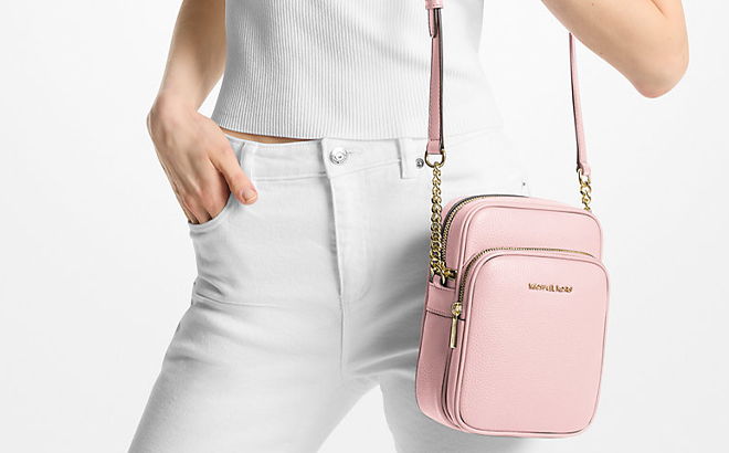A Woman Wearing Michael Kors Jet Set Travel Medium Pebbled Leather Crossbody Bag