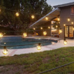 Addlon 100 Foot Outdoor Solar String Lights in a Backyard